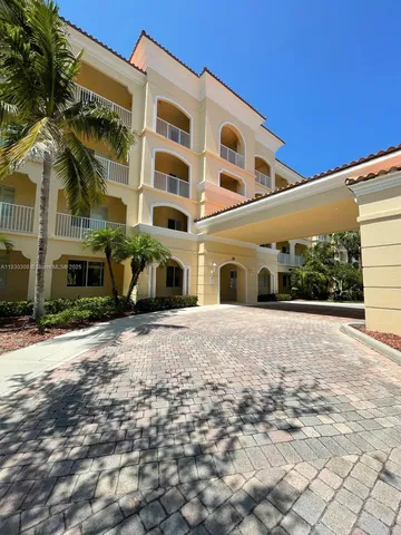 a front view of a building with a yard