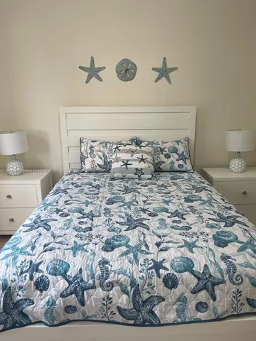 a large bed sitting in a bedroom next to a bathroom