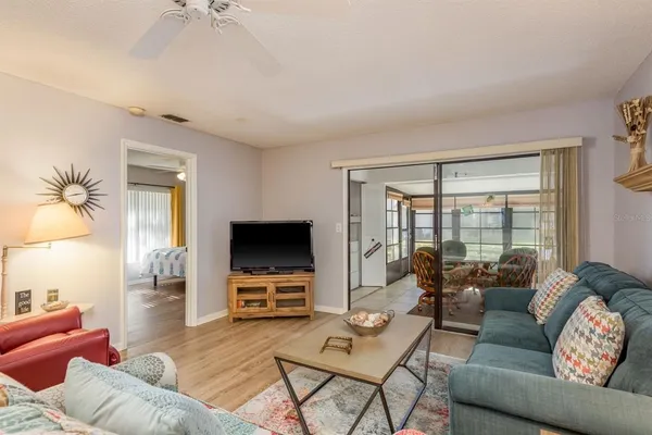 a living room with furniture a couch and wooden floor