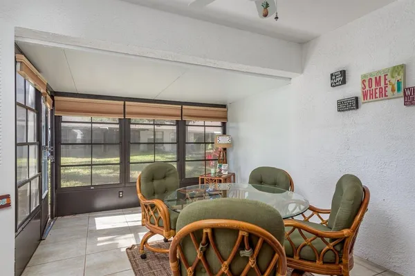 a living room with furniture and large windows