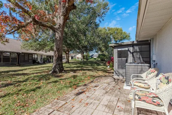 a view of a patio with table and chairs and potted plants