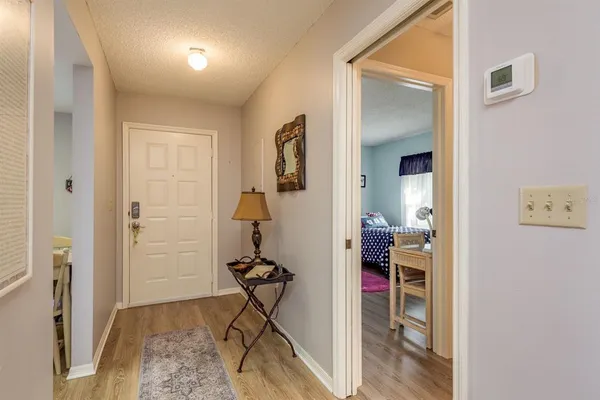a view of a hallway with closet and a livingroom view