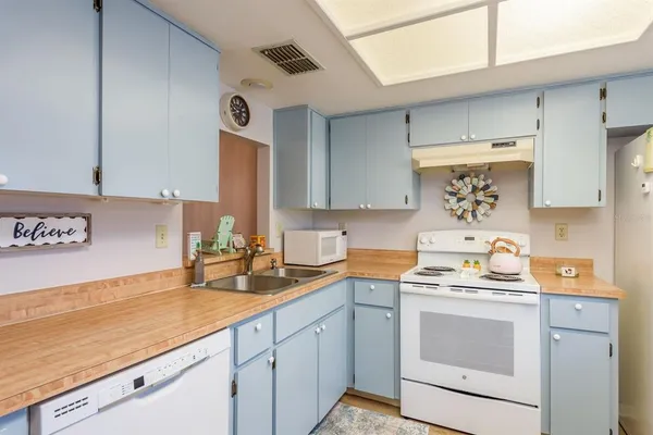 a kitchen with a refrigerator and a stove top oven