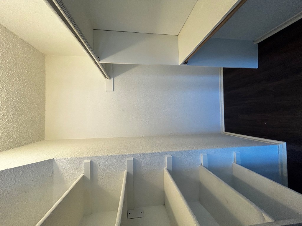 708 Graham Place, Unit 208 Austin, TX 78705 - Photo 6 of 9 a view of walk in closet with empty racks