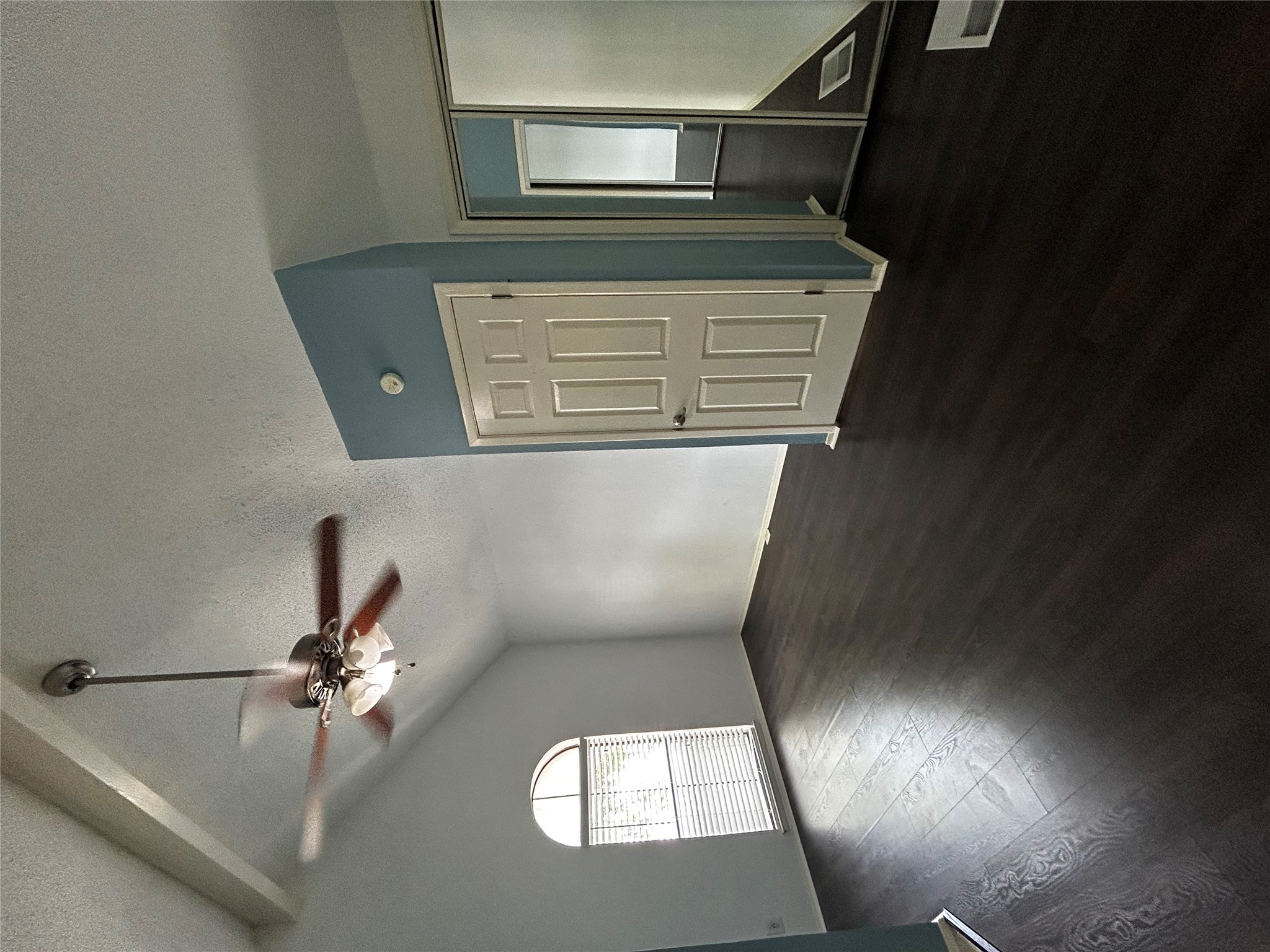 708 Graham Place, Unit 208 Austin, TX 78705 - Photo 7 of 9 Empty room featuring a textured ceiling, dark wood-style floors, and ceiling fan