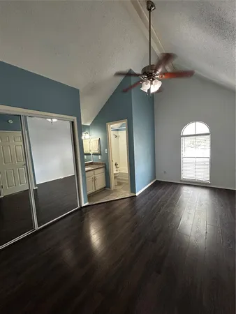a view of a livingroom with wooden floor and a ceiling fan