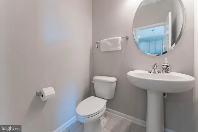 a kitchen with a sink a microwave and wooden floor