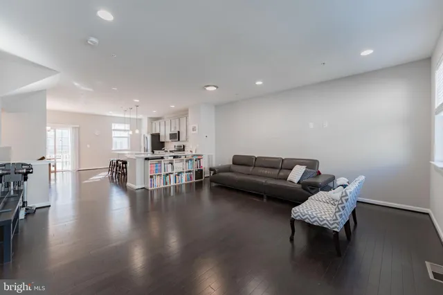 a large white kitchen with lots of counter space a sink and appliances
