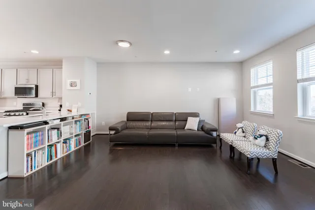 a living room with furniture and a flat screen tv with wooden floor