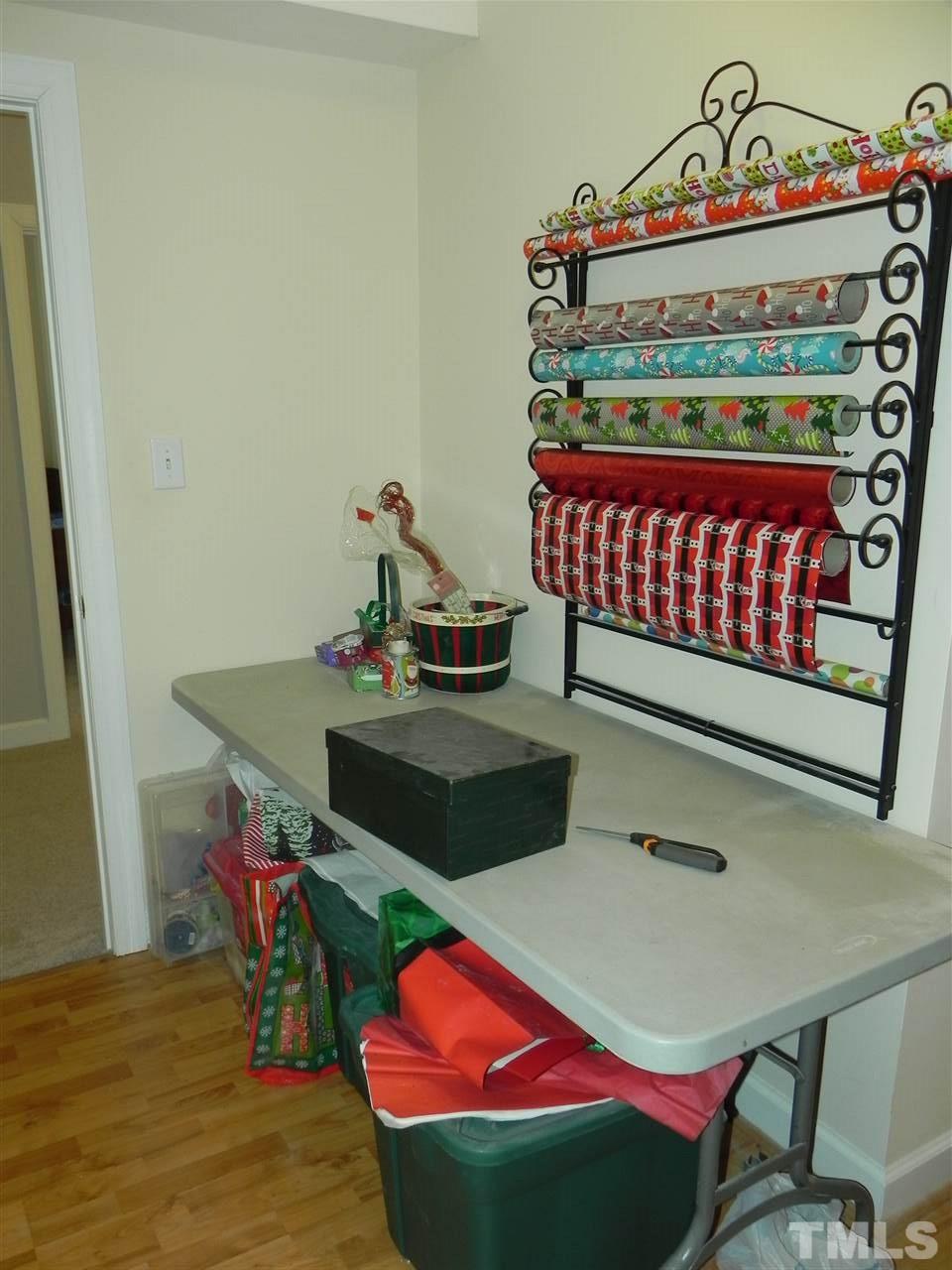 5505 Overleaf Court Raleigh, NC 27615 - Photo 20 of 25 Anyone Looking for a Craft Room or Workshop? This Room is Perfect for Either Option! The Room is L Shaped with Lots of Storage Options in the Adjacent Unfinished Area