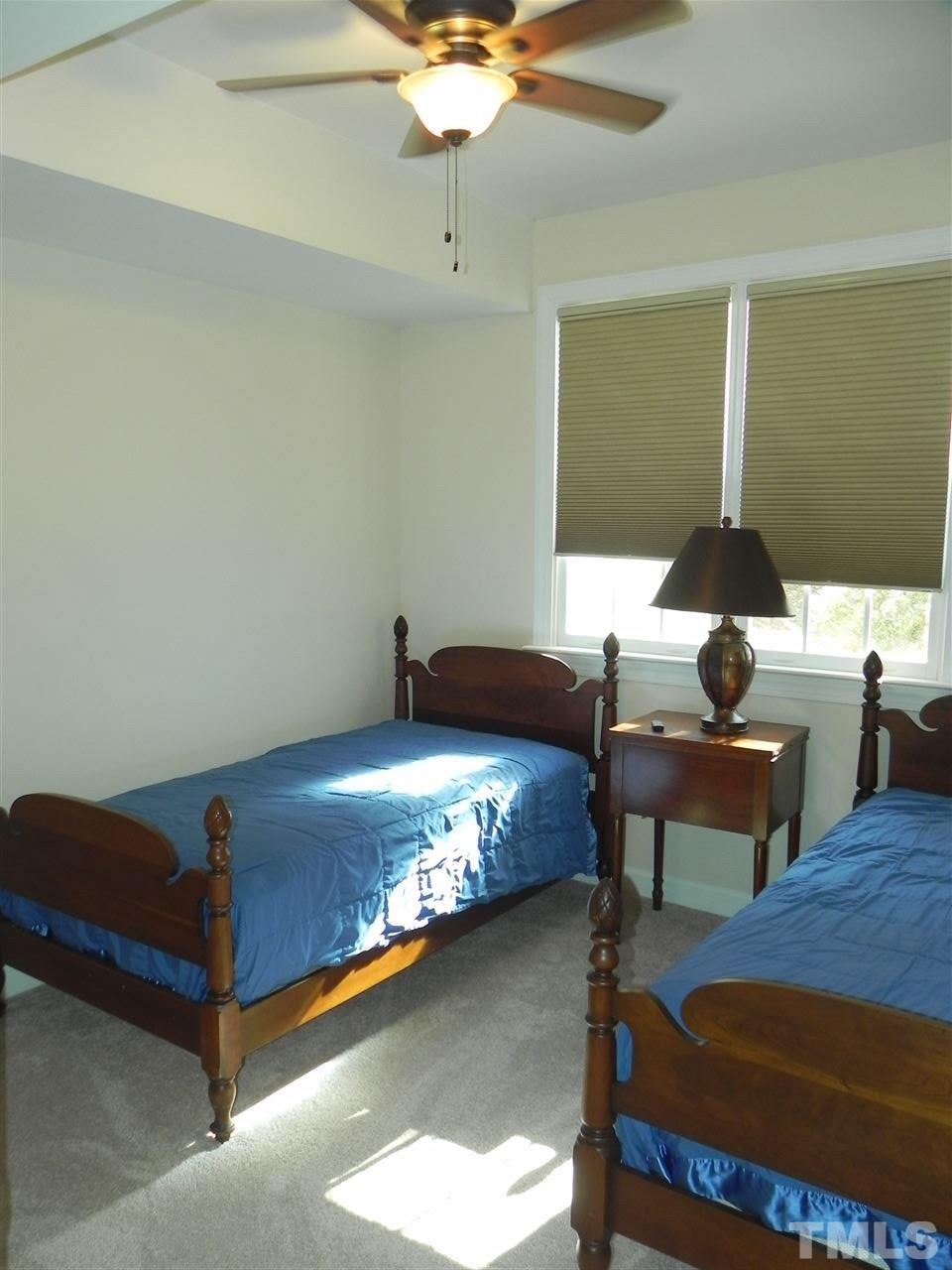 5505 Overleaf Court Raleigh, NC 27615 - Photo 21 of 25 Located in the Basement and Disguised as a Bedroom, This is a Fantastic Space to Have a Home Office Away from the Noises of the Household - Has a Large Walk-In Closet Filled w/Shelving to Hold Your Work Stuff.