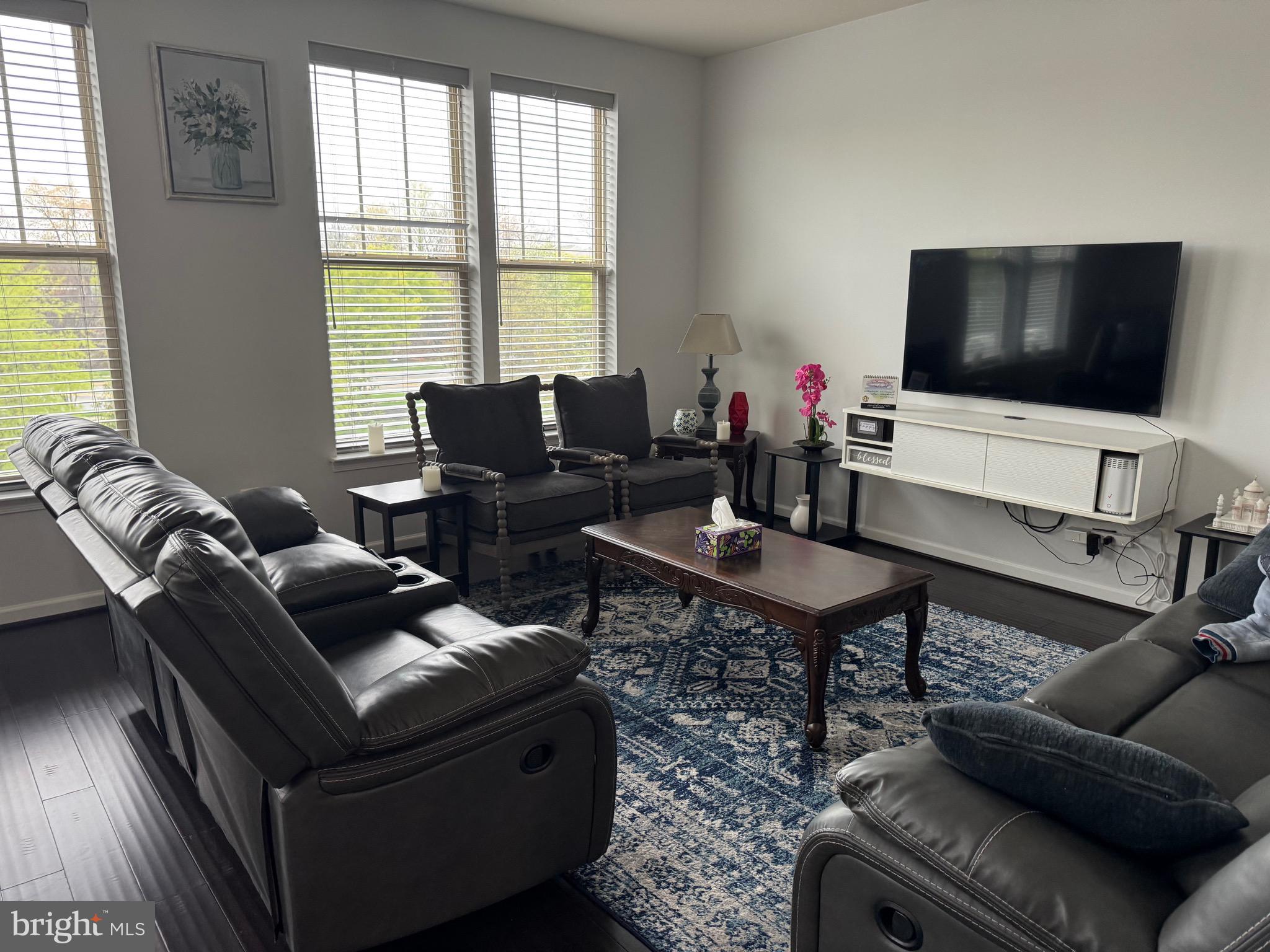8937 Garrett Way Manassas, VA 20112 - Photo 18 of 66 a living room with furniture and a flat screen tv