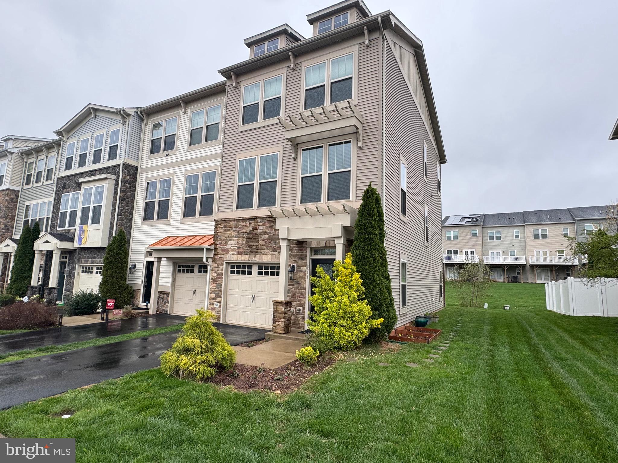 8937 Garrett Way Manassas, VA 20112 - Photo 2 of 66 a front view of a house with a yard