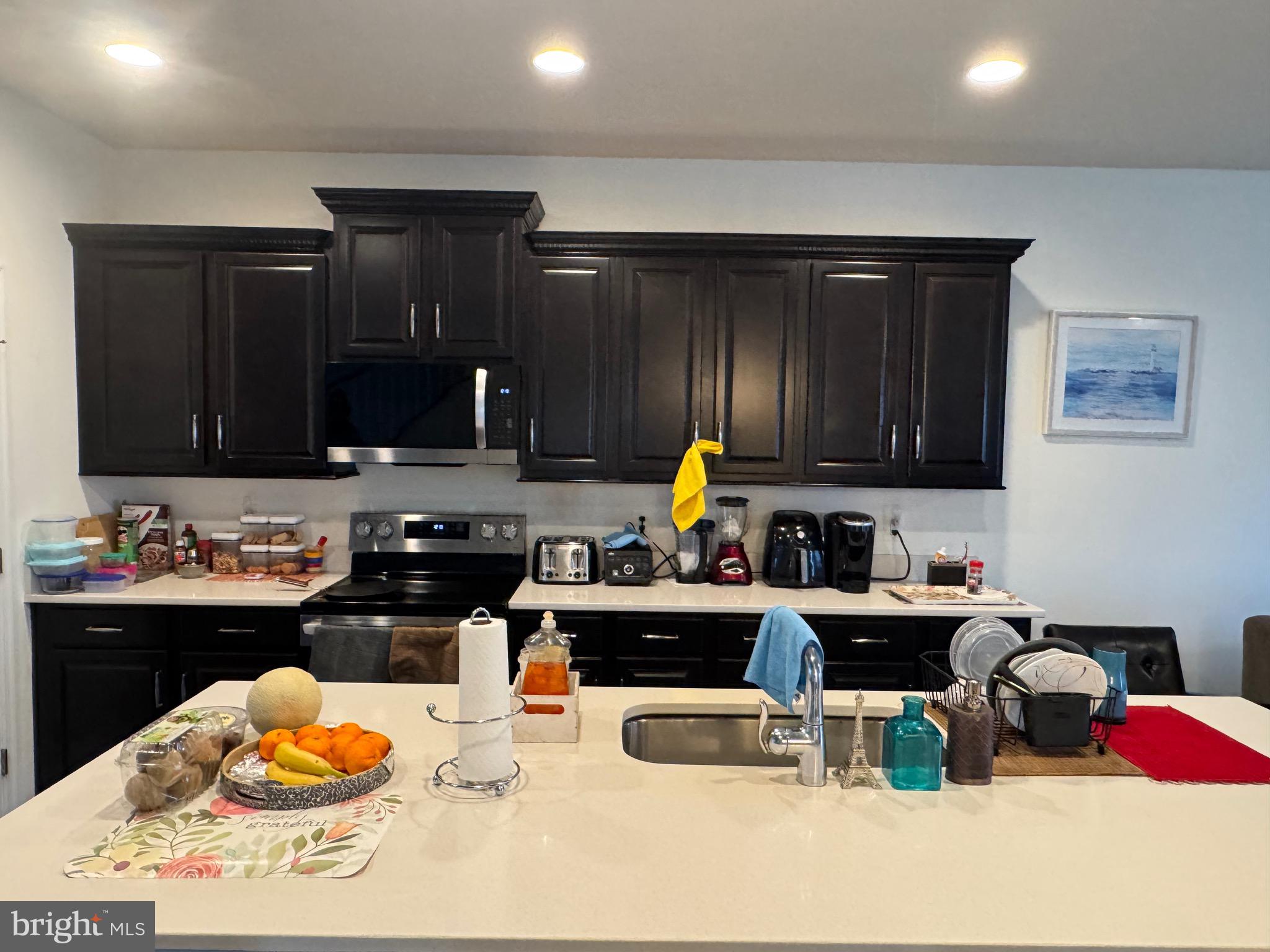 8937 Garrett Way Manassas, VA 20112 - Photo 22 of 66 a kitchen with stainless steel appliances a stove a sink and a refrigerator
