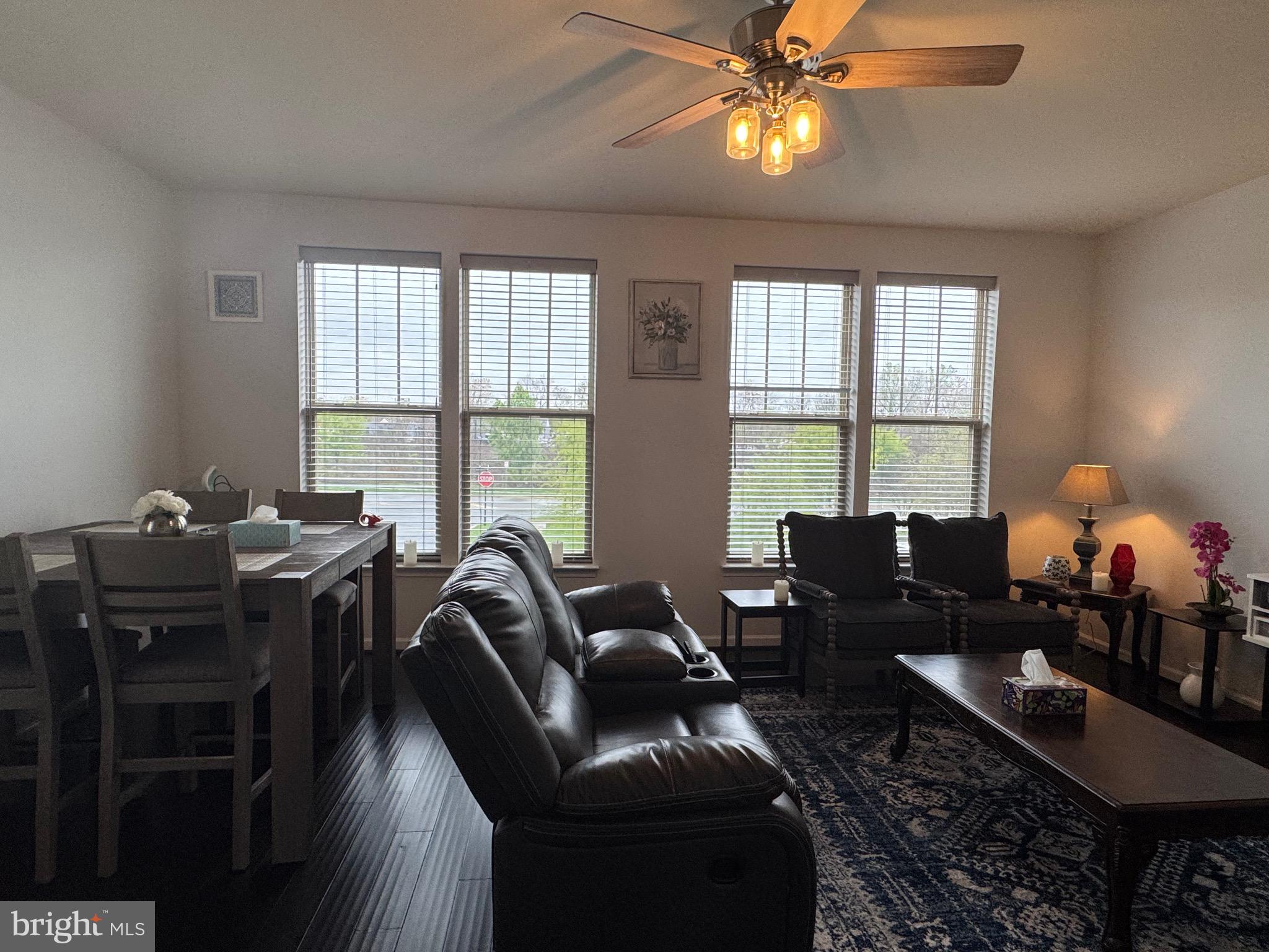 8937 Garrett Way Manassas, VA 20112 - Photo 27 of 66 a living room with furniture a chandelier and a window