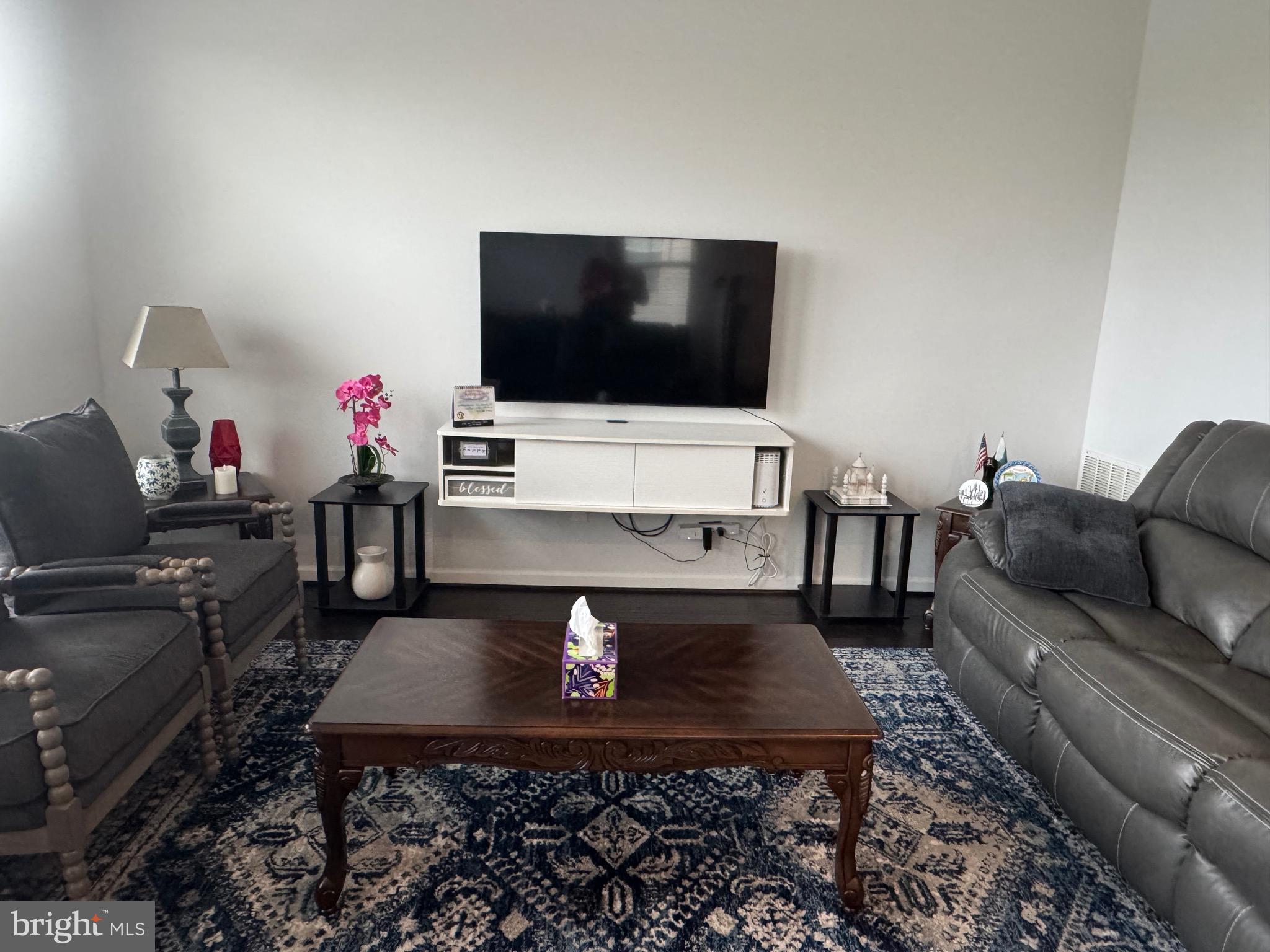 8937 Garrett Way Manassas, VA 20112 - Photo 28 of 66 a living room with furniture and a flat screen tv