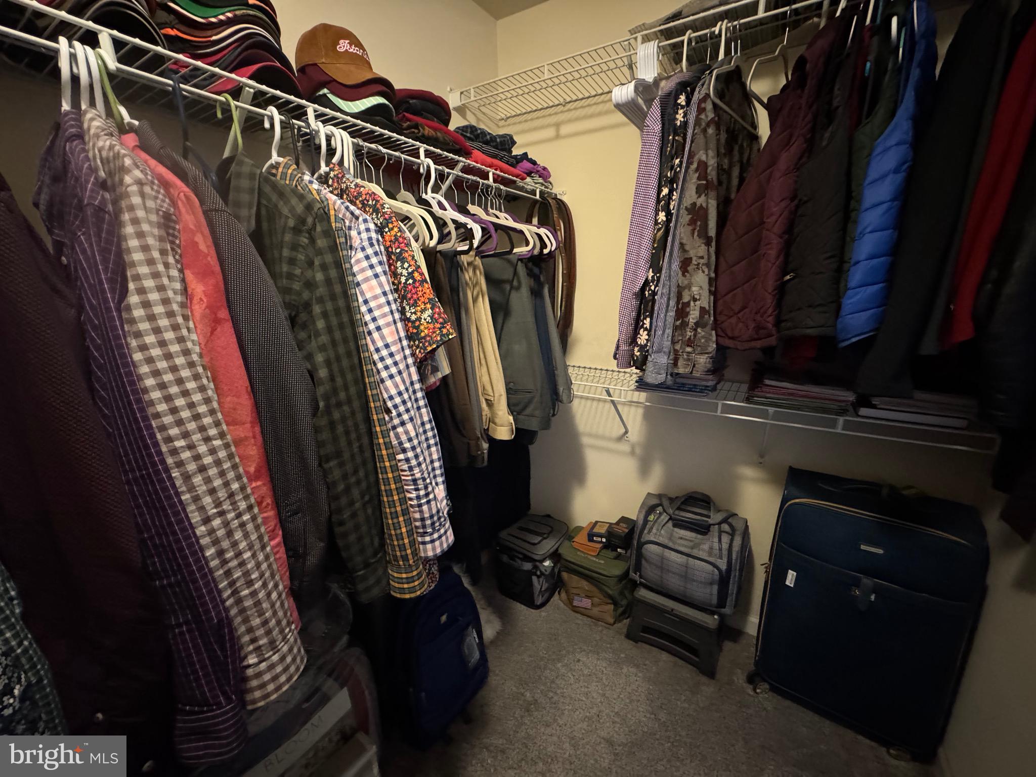 8937 Garrett Way Manassas, VA 20112 - Photo 35 of 66 a view of walk in closet with clothes and shoes