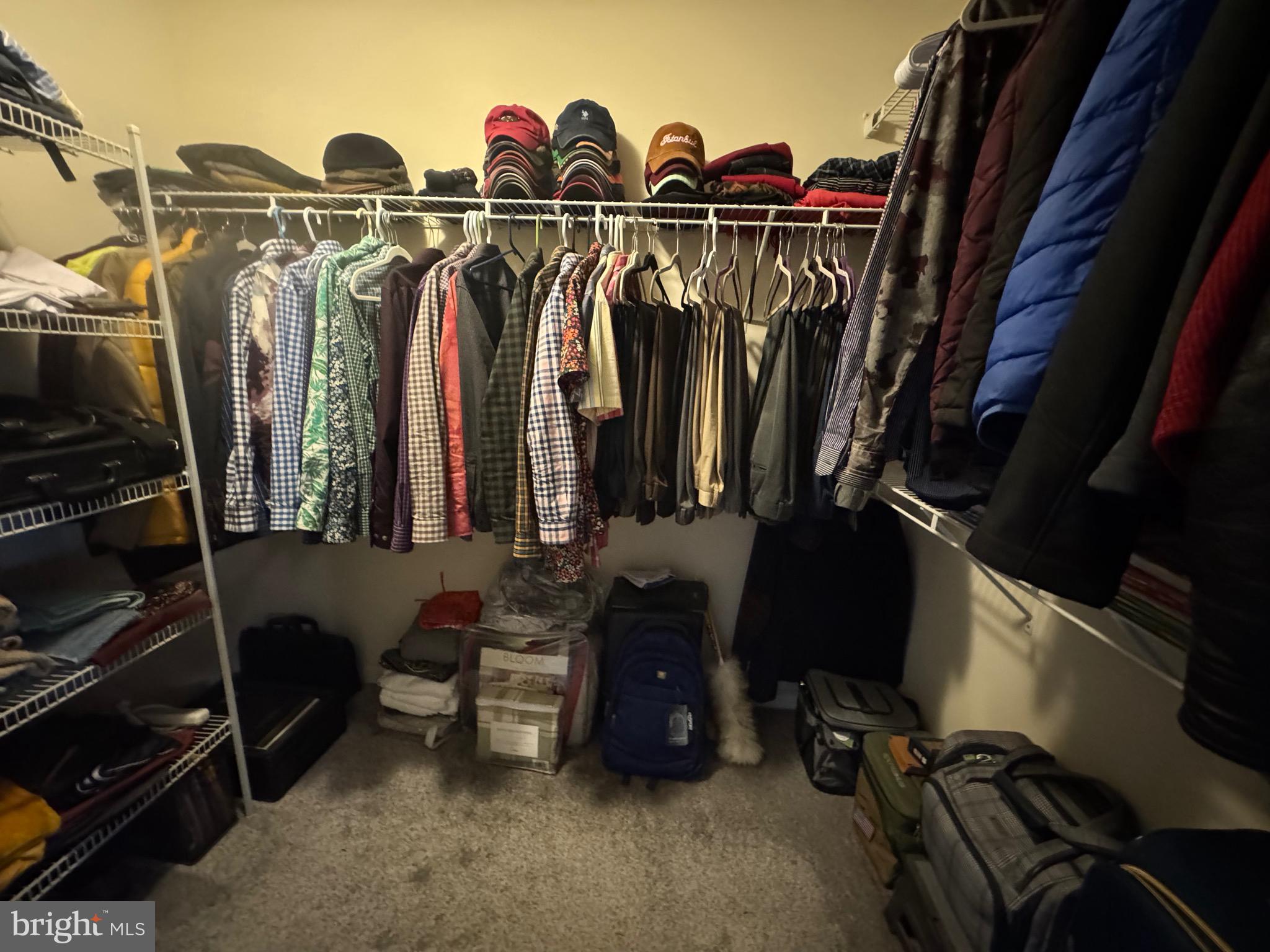 8937 Garrett Way Manassas, VA 20112 - Photo 37 of 66 a view of walk in closet with clothes and shoes