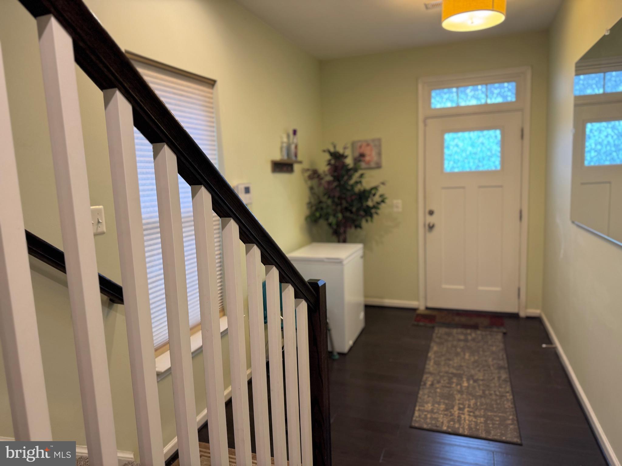 8937 Garrett Way Manassas, VA 20112 - Photo 53 of 66 a view of entryway with wooden floor and stairs