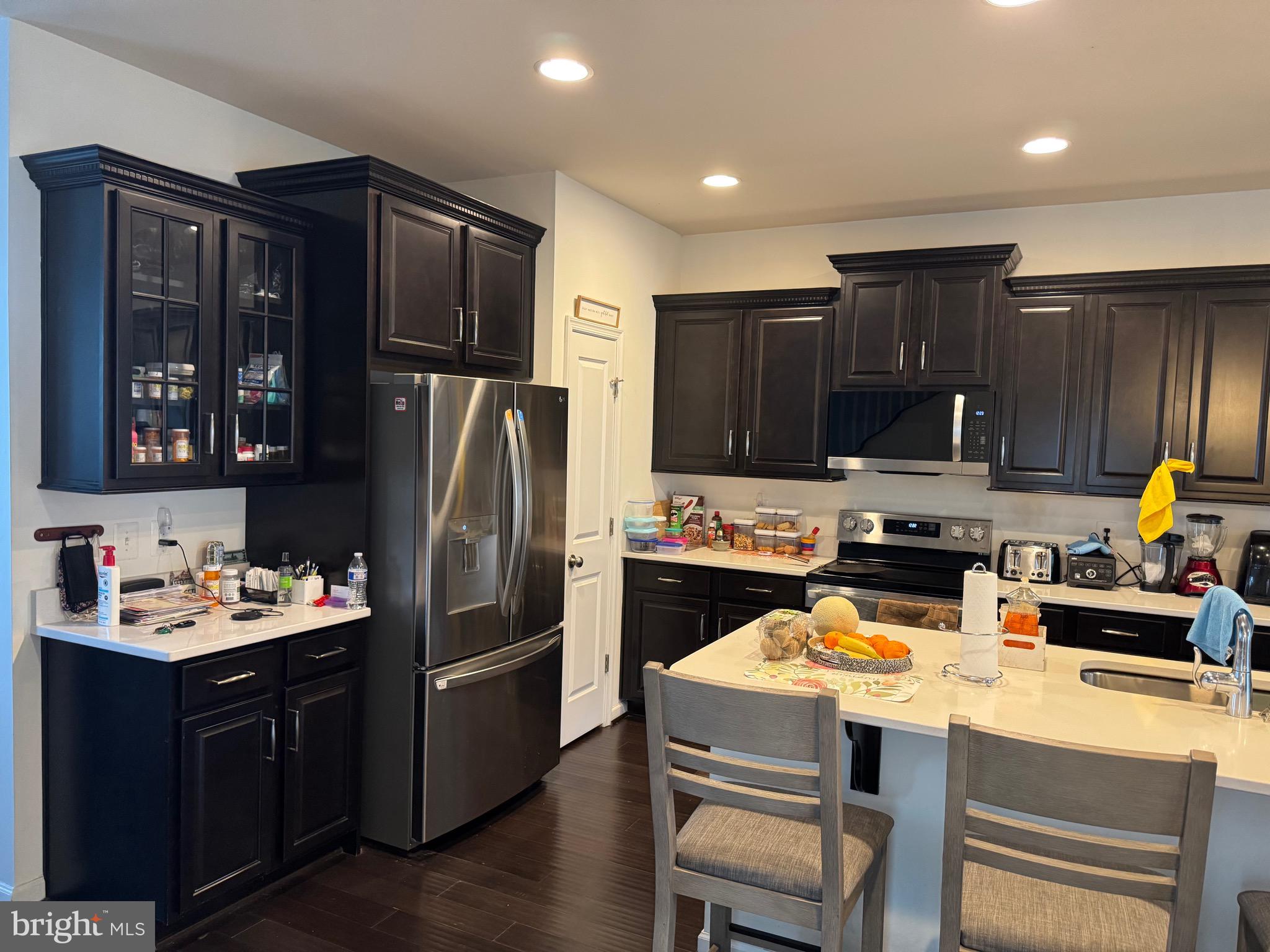 8937 Garrett Way Manassas, VA 20112 - Photo 8 of 66 a kitchen with a refrigerator a stove a sink and cabinets