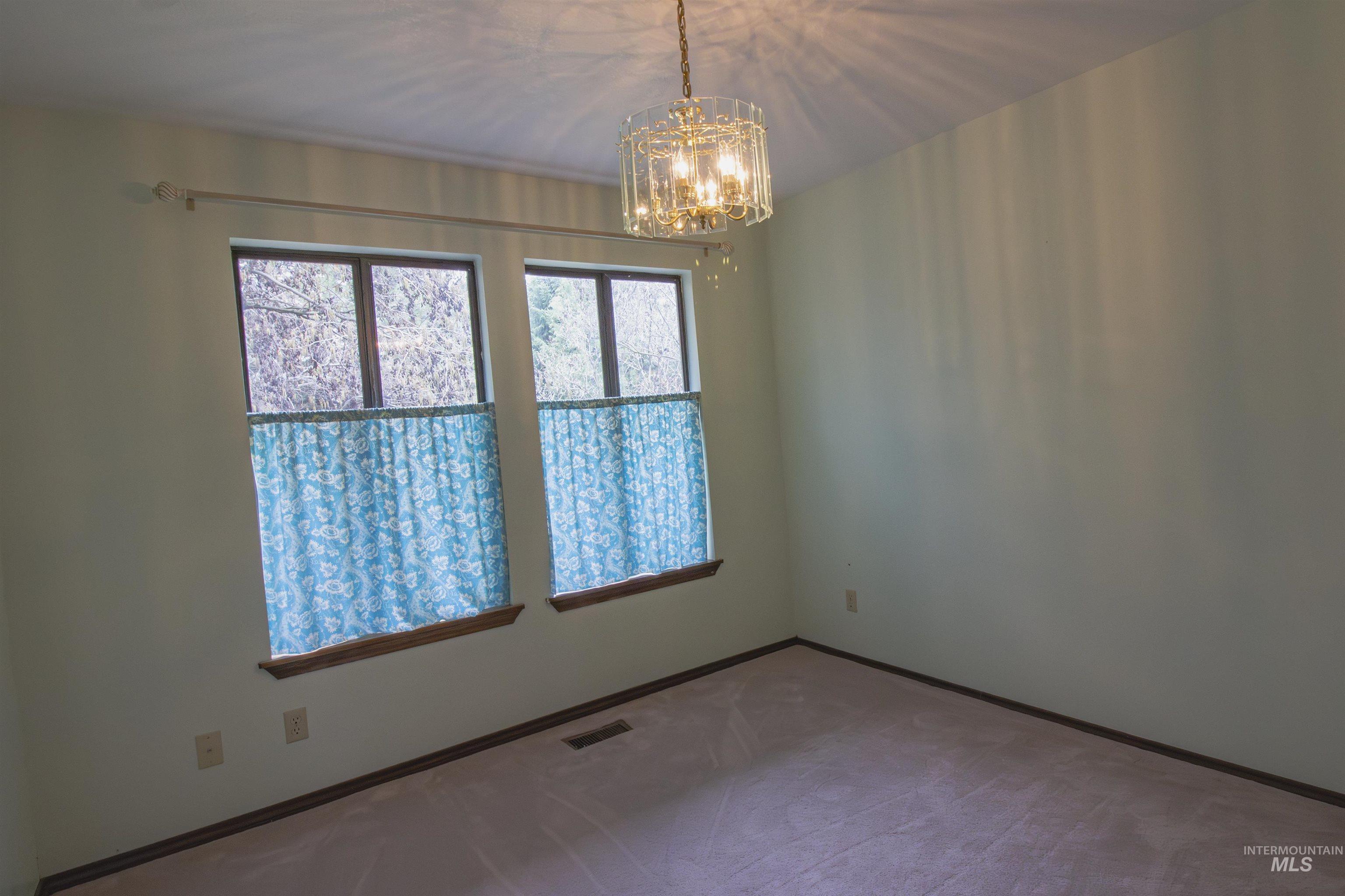2465 Center Avenue Payette, ID 83661 - Photo 15 of 39 Bedroom with hanging lights and baseboards