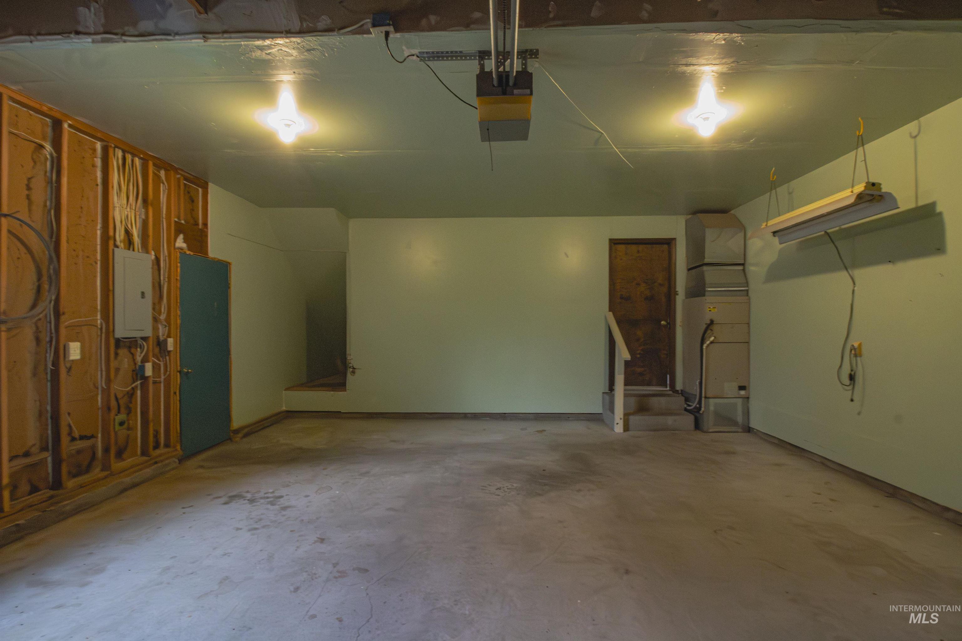 2465 Center Avenue Payette, ID 83661 - Photo 23 of 39 Garage featuring electric panel, heating unit, and a garage door opener