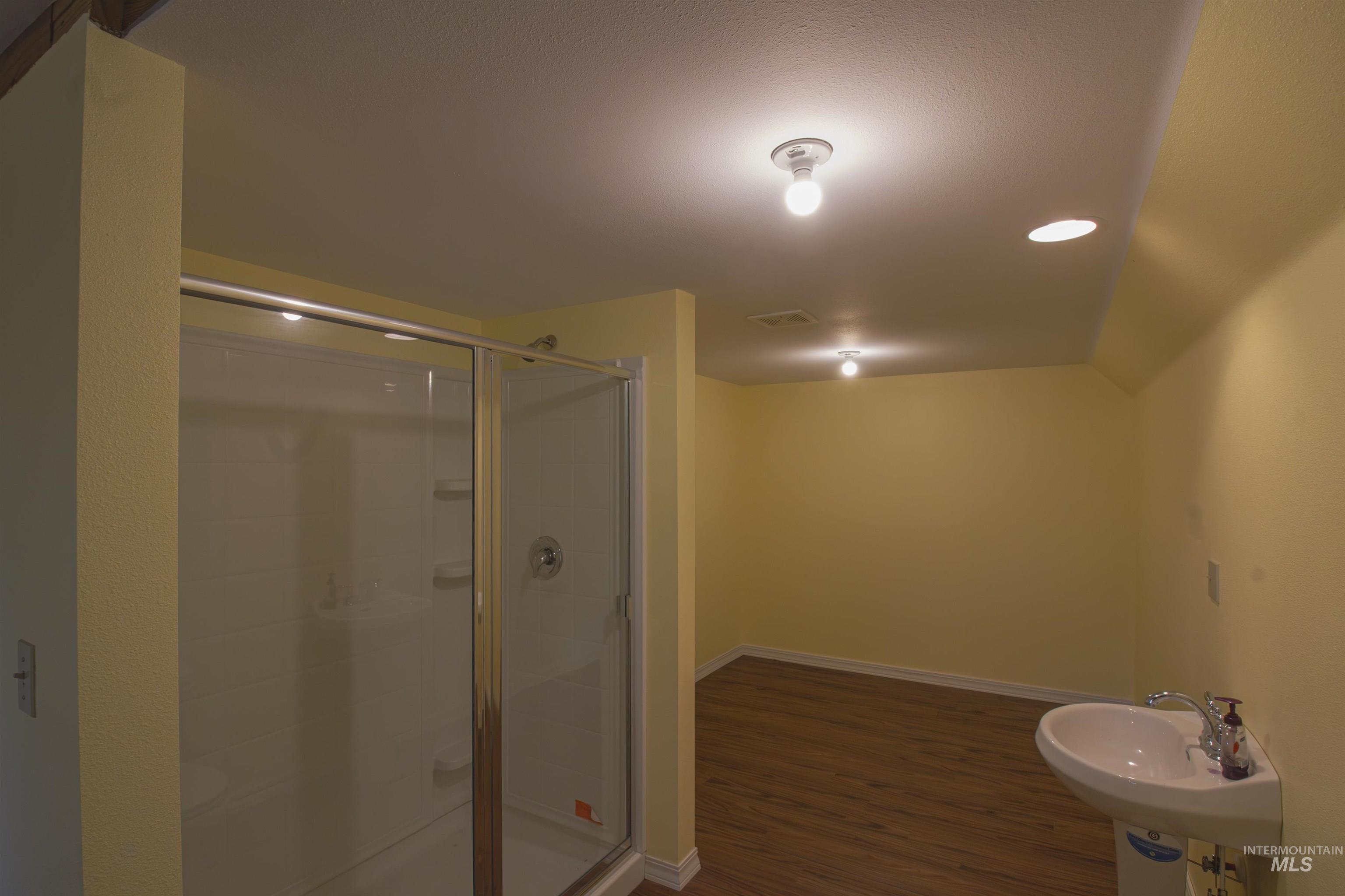 2465 Center Avenue Payette, ID 83661 - Photo 27 of 39 Full bathroom featuring a stall shower, recessed lighting, and dark wood-style floors