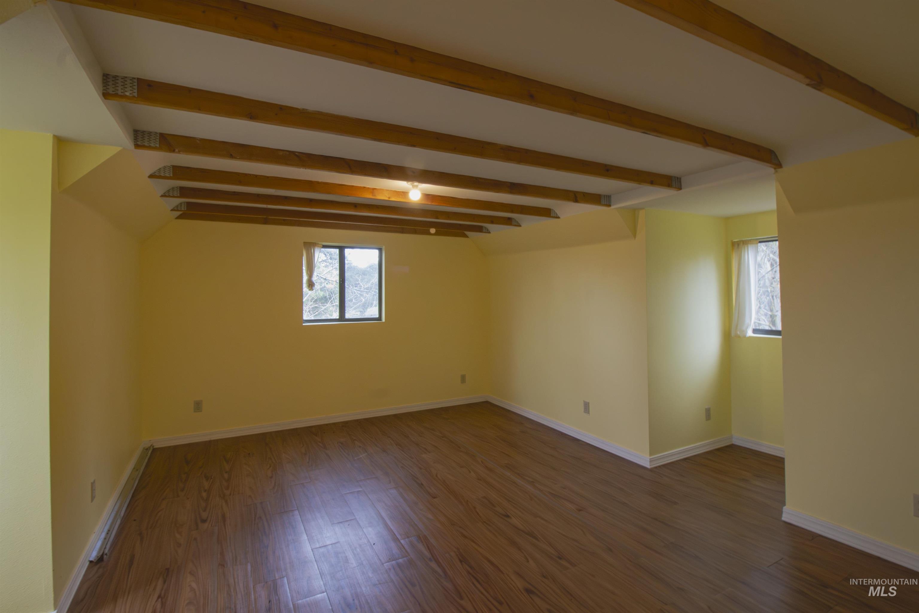 2465 Center Avenue Payette, ID 83661 - Photo 28 of 39 Upstairs bedroom room featuring dark wood finished floors and beam ceiling
