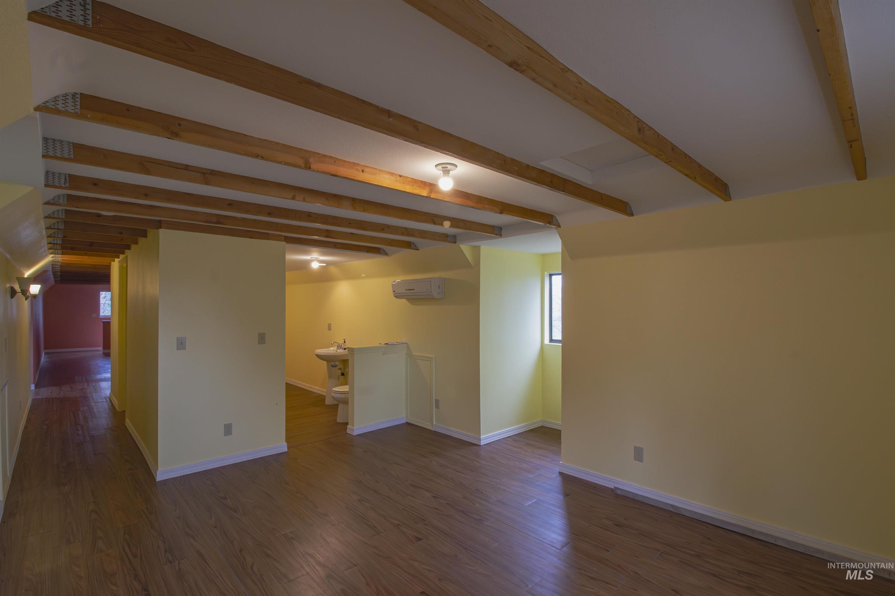 2465 Center Avenue Payette, ID 83661 - Photo 29 of 39 Upstairs bedroom featuring beam ceiling and dark wood-type flooring