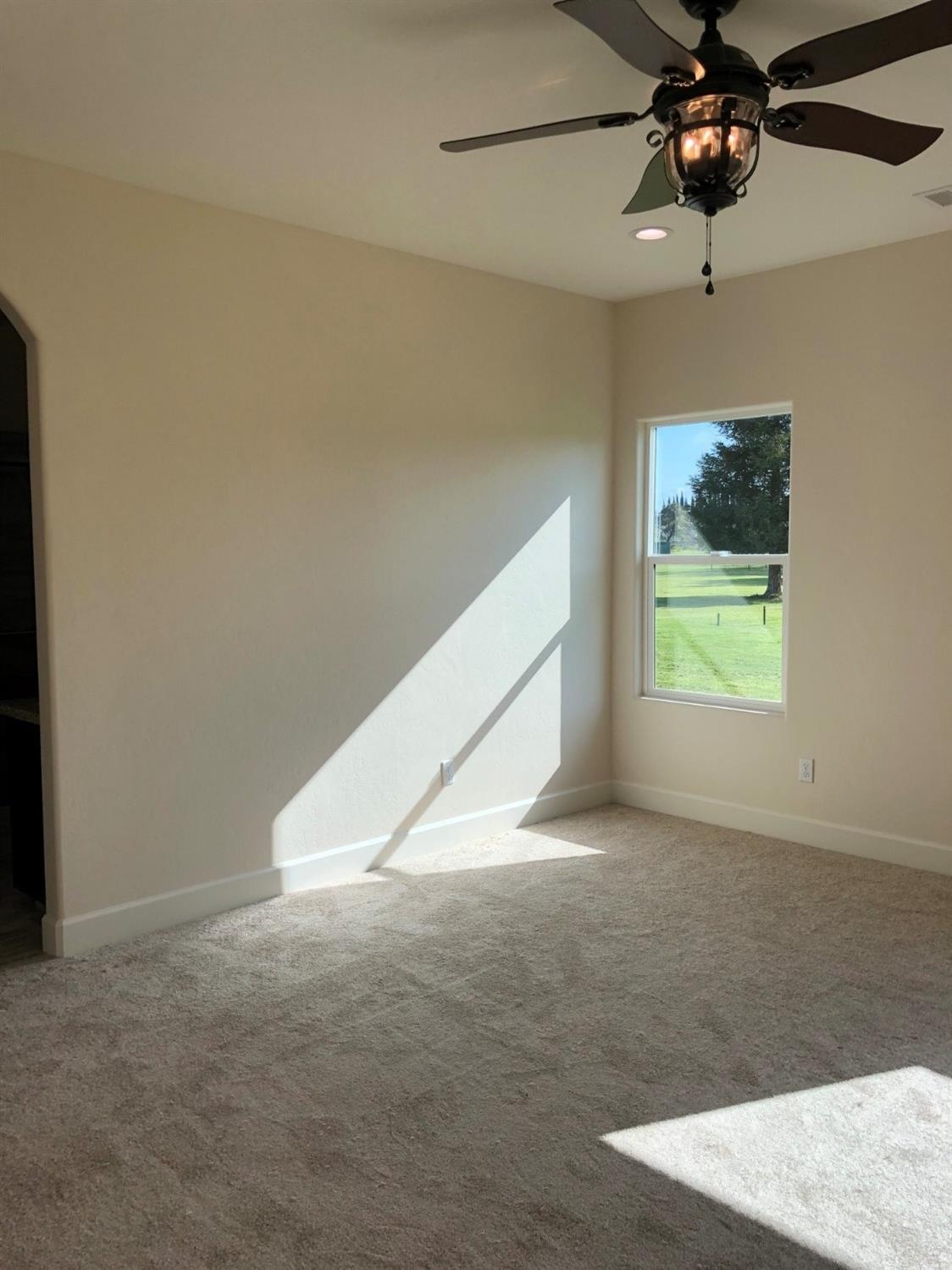 159 North Belmont Road Exeter, CA 93221 - Photo 21 of 28 an empty room with ceiling fan and window