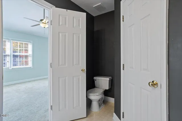 a white toilet sitting next to a bathroom sink