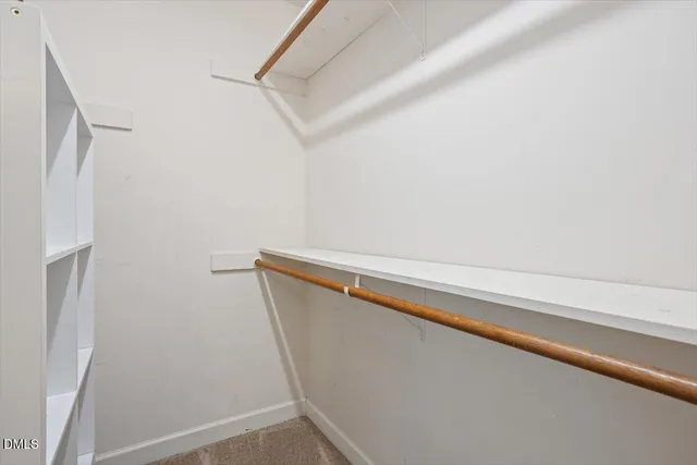 a view of closet with wooden floor
