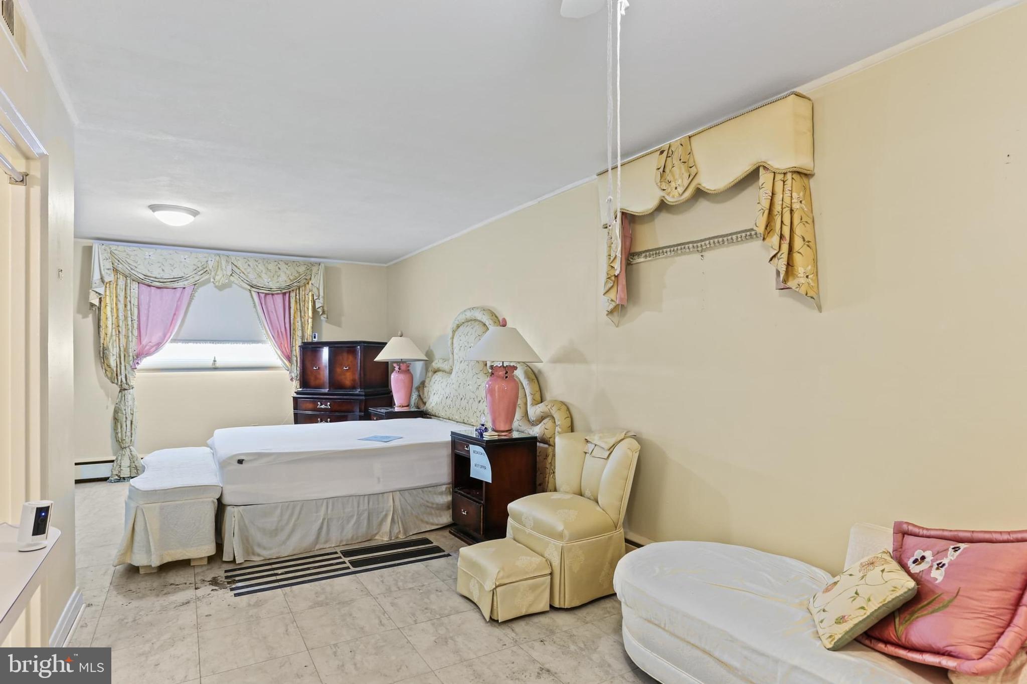 7613 Carla Road Baltimore, MD 21208 - Photo 15 of 24 a bedroom with a bed and a potted plant