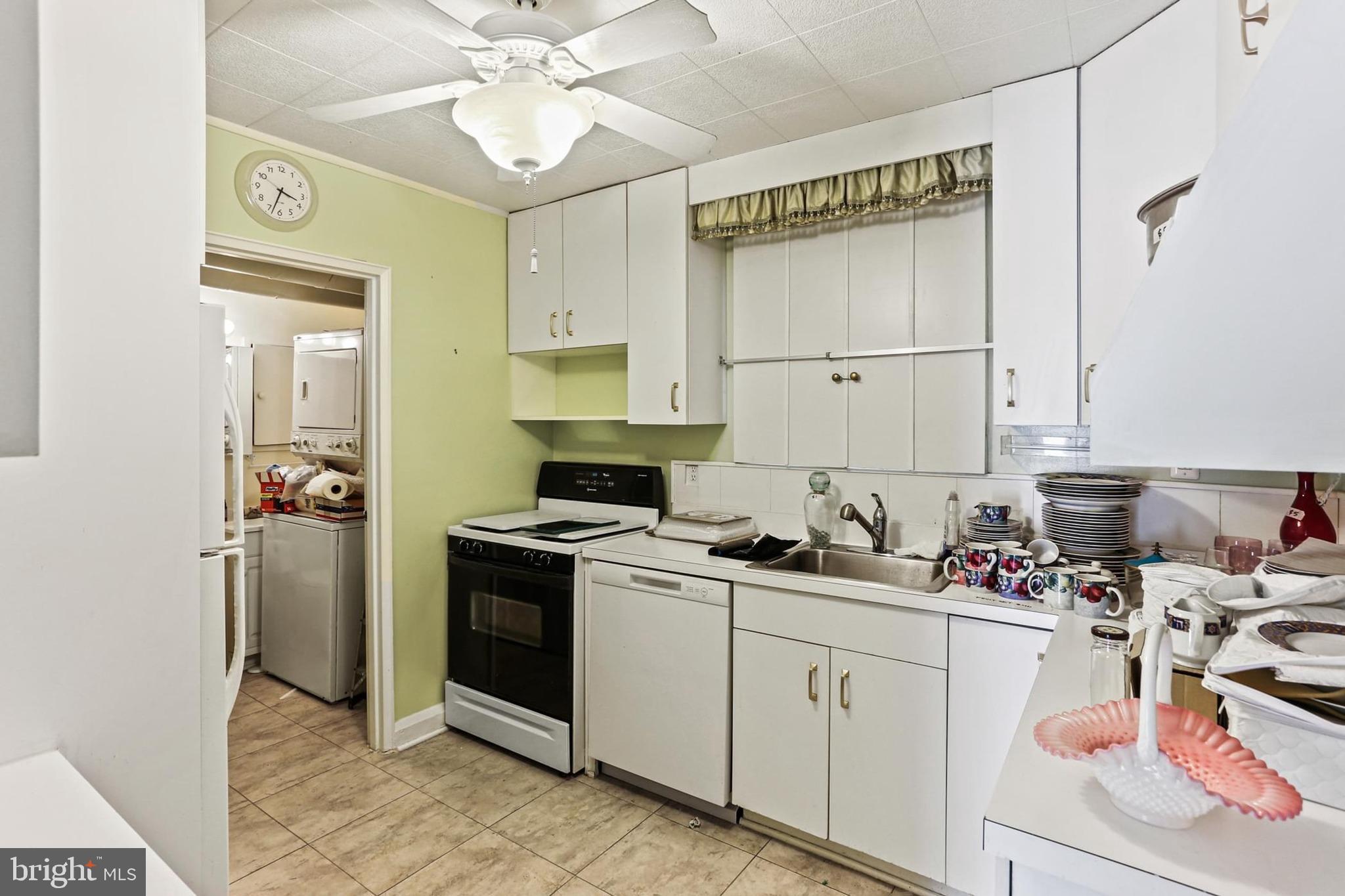 7613 Carla Road Baltimore, MD 21208 - Photo 7 of 24 a kitchen with a sink stove and cabinets