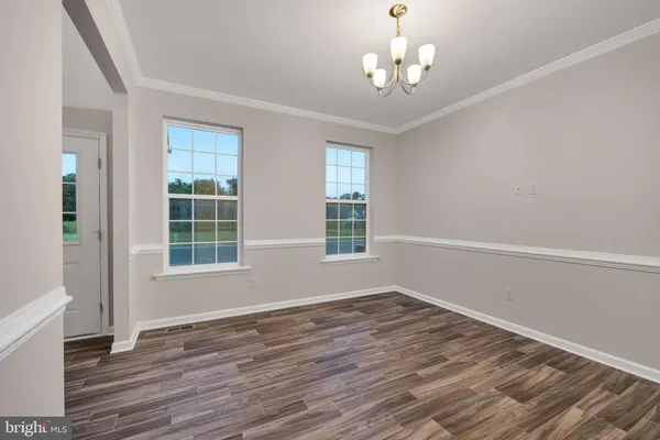 a view of wooden floor and windows in a room