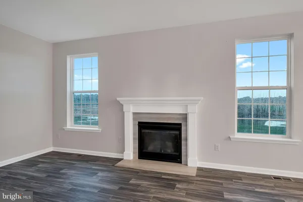 a living room with a fireplace and windows