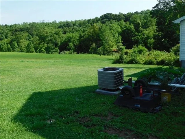 a view of a chair and table in the garden