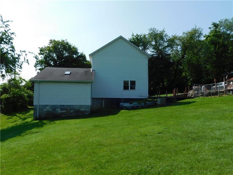 577 Woodside Old Frame Road Smithfield, PA 15478 - Photo 12 of 49 a view of a backyard with potted plants and large trees
