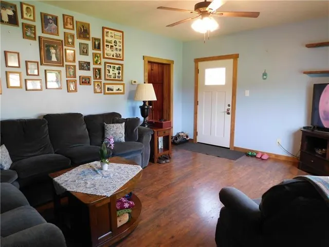 a living room with furniture and wooden floor