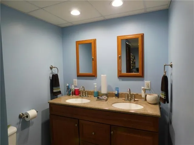 a bathroom with a double vanity sink and a mirror