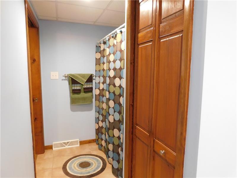 577 Woodside Old Frame Road Smithfield, PA 15478 - Photo 25 of 49 a bathroom with a sink and a shower curtain