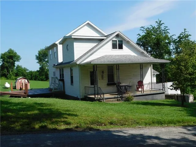 a front view of a house with a garden and porch