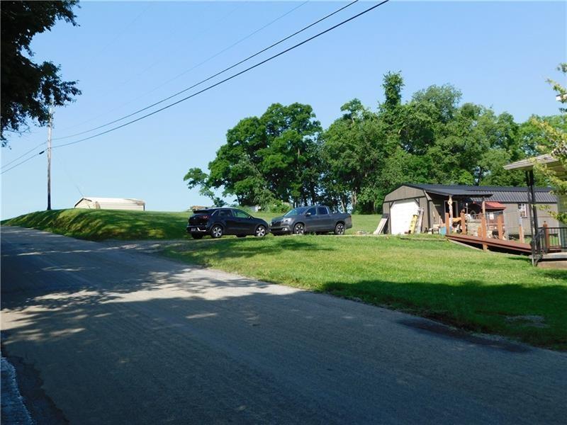 577 Woodside Old Frame Road Smithfield, PA 15478 - Photo 6 of 49 a backyard of a house with plants and large trees
