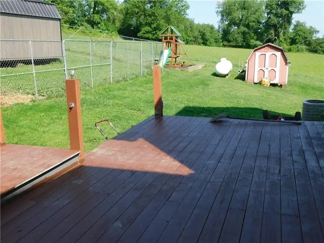a backyard of a house with barbeque oven