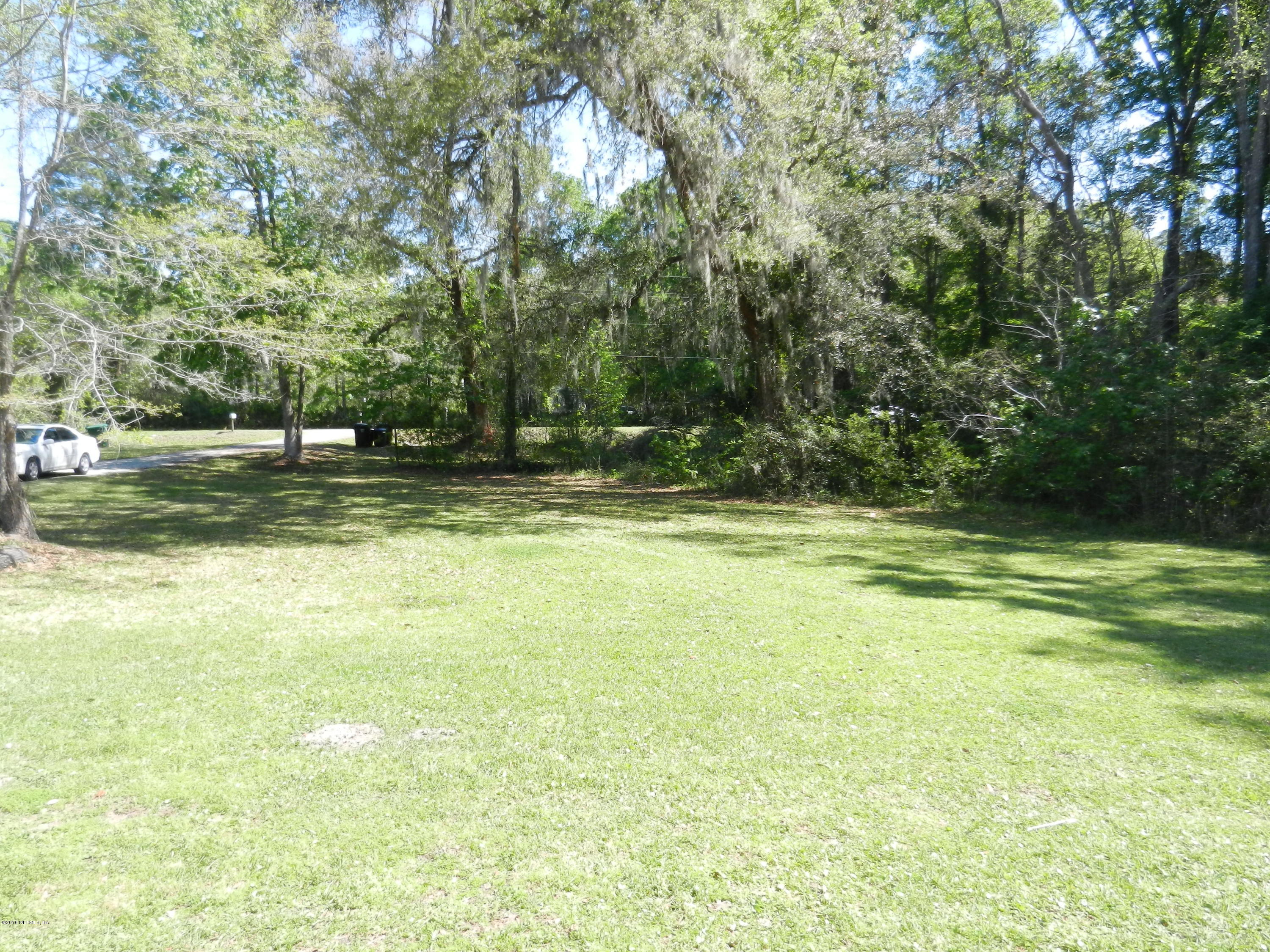 86232 Pages Dairy Road Yulee, FL 32097 - Photo 11 of 13 a view of a swimming pool with a yard