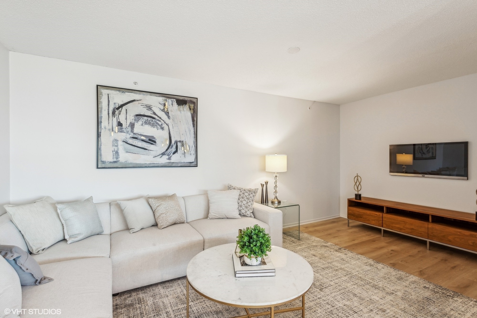 800 Elgin Road, Unit 511 Evanston, IL 60201 - Photo 13 of 29 a living room with furniture and a wooden floor