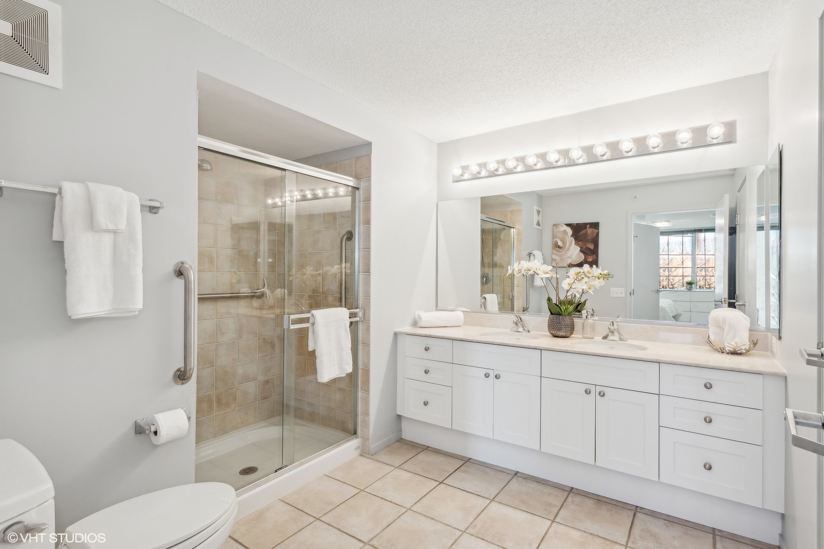 800 Elgin Road, Unit 511 Evanston, IL 60201 - Photo 16 of 29 a spacious bathroom with a granite countertop sink mirror and toilet