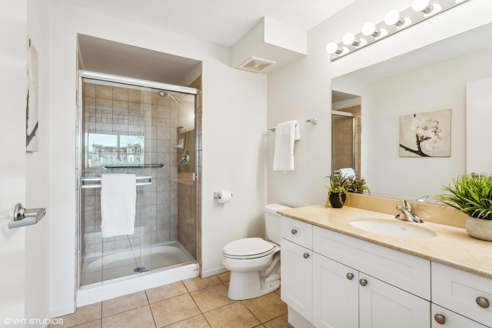 800 Elgin Road, Unit 511 Evanston, IL 60201 - Photo 20 of 29 a spacious bathroom with a granite countertop sink toilet a shower and a mirror