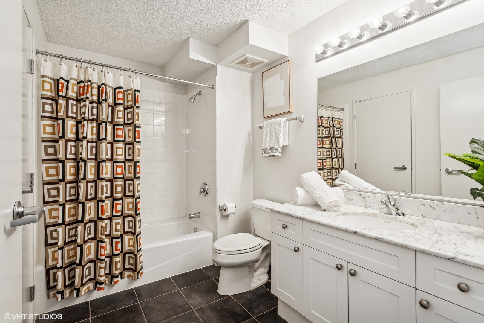 800 Elgin Road, Unit 511 Evanston, IL 60201 - Photo 22 of 29 a bathroom with a granite countertop sink toilet a shower and a mirror