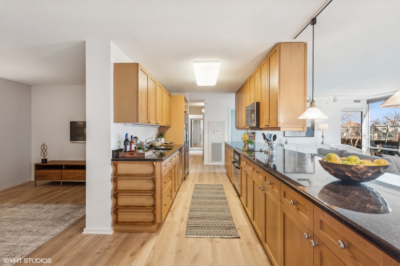 800 Elgin Road, Unit 511 Evanston, IL 60201 - Photo 10 of 29 a kitchen with stainless steel appliances granite countertop a stove a sink and a wooden floors